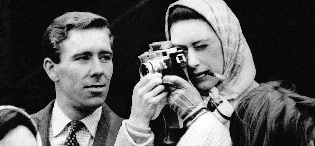 Fag in mouth, Princess Margaret tries out a Leica, watched by her husband, Lord Snowdon