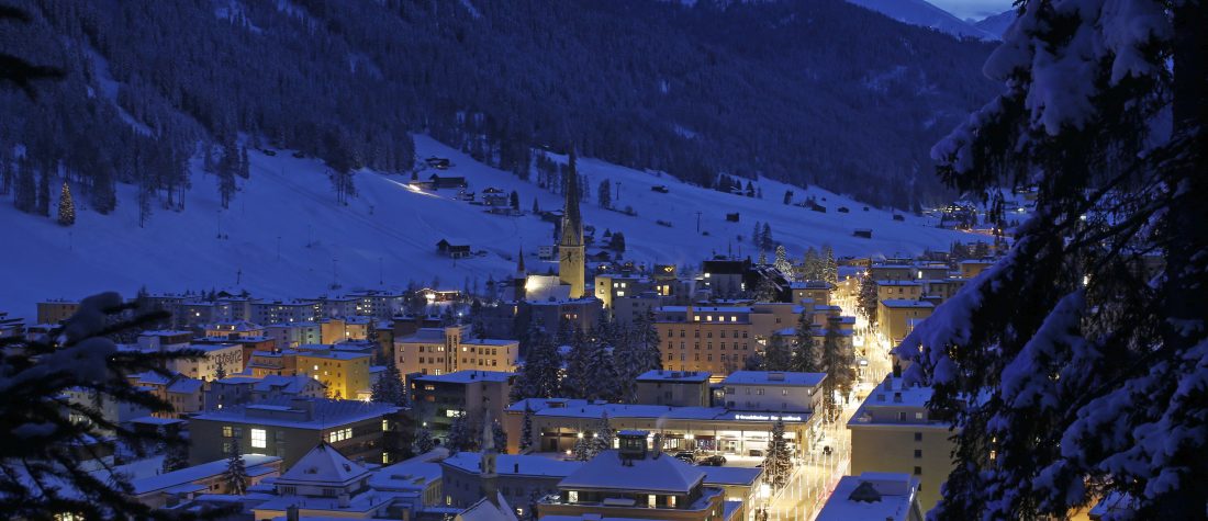 Residential buildings stand illuminated on the town skyline ahead of the World Economic Forum (WEF) in Davos, Switzerland. Photographer: Simon Dawson/Bloomberg