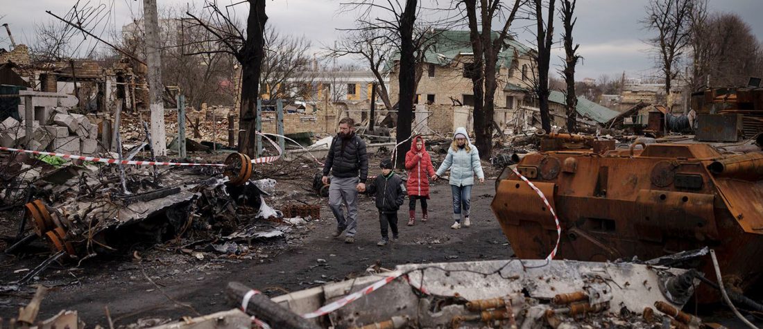 A family walks amid destroyed Russian tanks in Bucha, on the outskirts of Kyiv, Ukraine, Wednesday, April 6, 2022. (AP Photo/Felipe Dana)

------------------