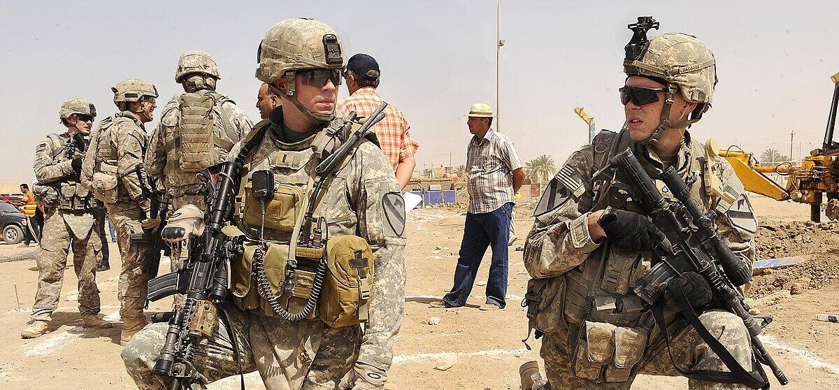 U.S. Army 1st Lt. Joshua Vandegriff of Lynchburg, Va., and Pfc. Joshua Cahoon of Wolcott, N.Y., with 2nd Battalion, 5th Cavalry Regiment, 1st Brigade Combat Team, 1st Cavalry Division have a conversation while attending a groundbreaking ceremony of Freedom Field being built near Joint Security Station Ur, Baghdad, Iraq, June 23.