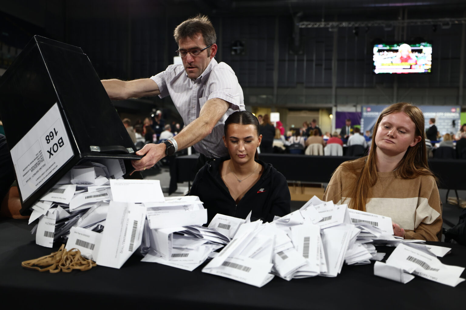 GLASGOW, SCOTLAND - JULY 4: Ballot papers are tipped out onto a table by counting staff at the counting centre at Emirates Arena as the UK general election count begins on July 4, 2024 in Glasgow, Scotland. Voters in 650 constituencies across the UK are electing members of Parliament to the House of Commons, after the prime minister announced a snap election on May 22, 2024. (Photo by Jeff J Mitchell/Getty Images)